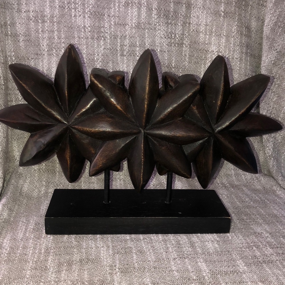Heavy wood flower sculpture.
